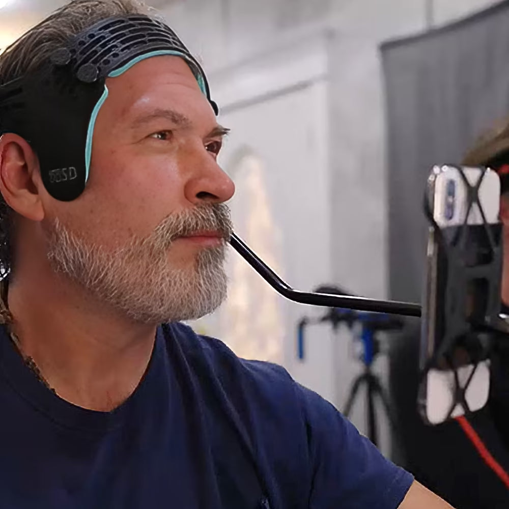 FaceCam iPhone HMC mocap helmet for Metahuman Animator worn by actor, featuring head-mounted iPhone rig for facial motion capture in studio setup.